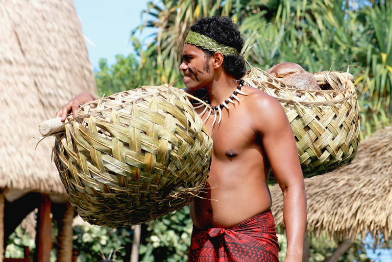 Polynesian Cultural Center carrying handwoven baskets.