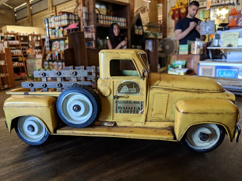 An old school toy truck showing it's branded "old sugar mill" sticker can be found near the entrance of the old Waialua sugar mill.