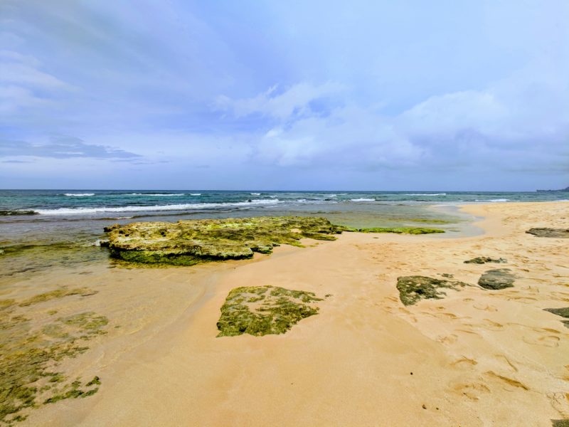 Where the rocks end and the sand begins at Papailoa beach. The Best Beaches In Oahu’s North Shore For Families.