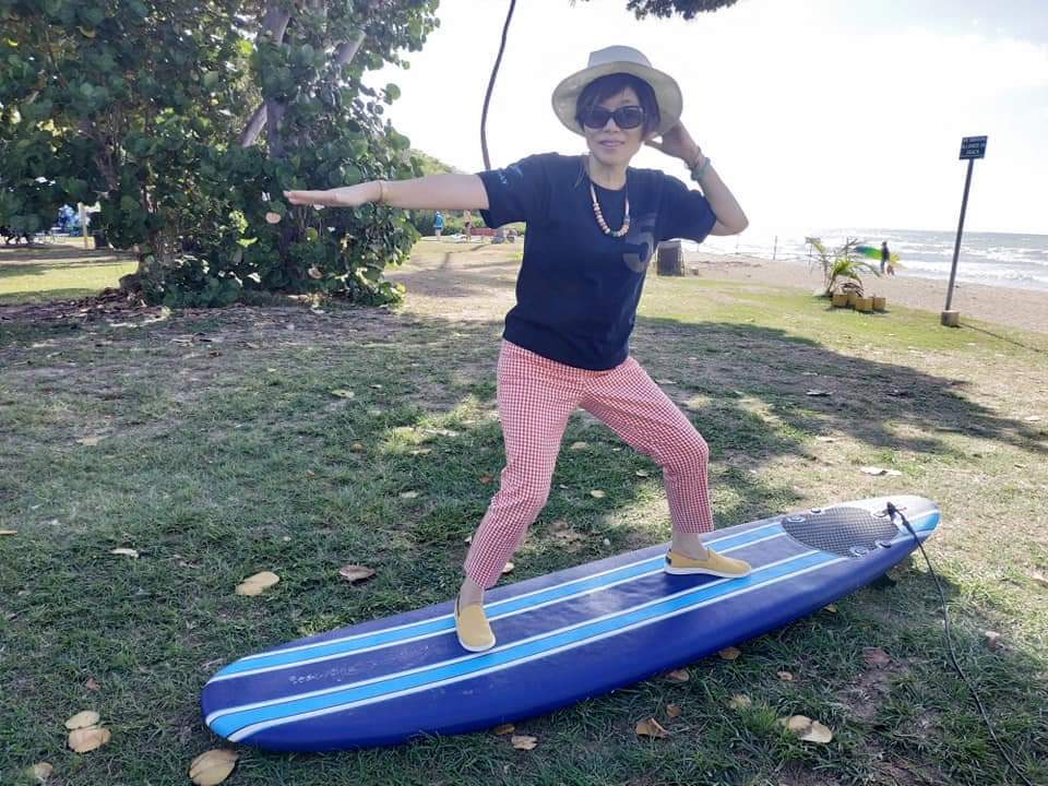My Aunty on a surfboard for fun at White Plains Beach.