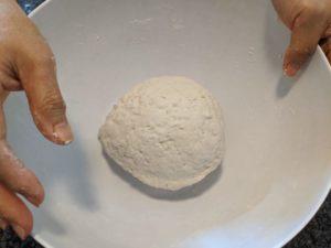 Knead until you get a smooth ball and all the loose flour has joined the ball of dough.