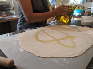 Spread the oil around until it covers the entire surface area of the dough.
