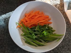 Cut the green onions at a long diagonal to match the carrots and potatoes.