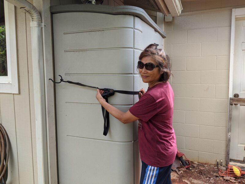 Mom securing our garden shed for the coming hurricane.