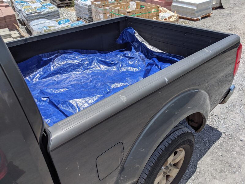 Lining the truck with a heavy-duty tarp.