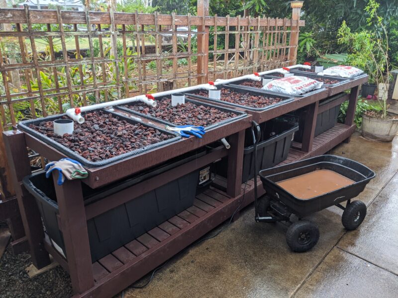 Moving the lava rock from truck to grow bed is complete.