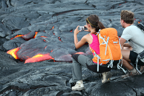 Watching the lava flow from Kilauea Volcano near the Hawaii Volcanoes National Park on the Big Island of Hawaii.