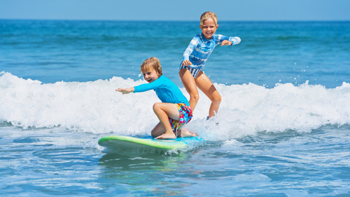 Learning to surf in the summer in Hawaii is a perfect tiem for little kids as the waves are gentle islandwide.