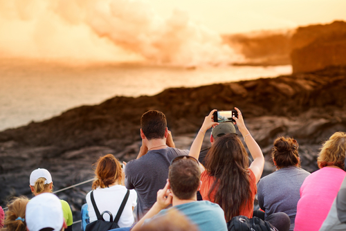 Hawaii Volcanoes National Park: Visitors watching lava pour into the ocean on the Big Island. Hawaii travel. Things to do on the Big Island. Things to do in Hawaii.