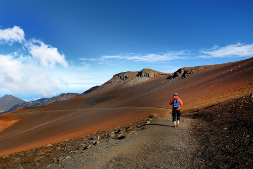 Hiking the Haleakala volcano crater on the Sliding Sands Trail. There's a beautiful view of the crater floor and cinder cones below.