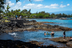 A family enjoying the waters at Richardson Beach Park on the Big Island. Editorial credit: Chris Allan / Shutterstock.com