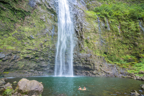 A couple enjoying the Hanakapiai Falls' swimming hole.