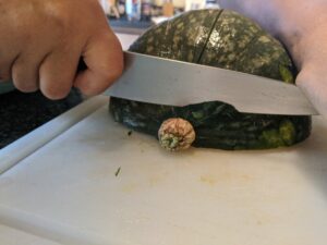Cut the kabocha in half and cut off the stem.
