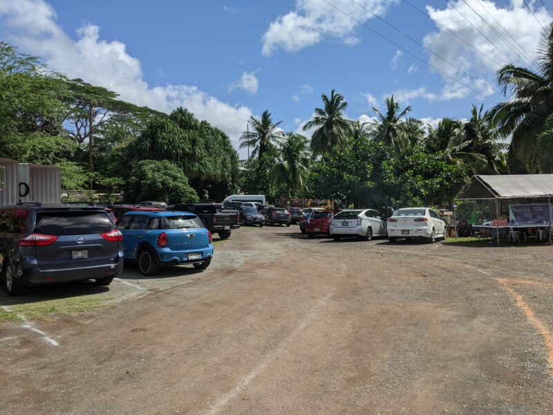 The parking lot as soon as you turn in from Farrington Highway. We were the first car parked on the side of the road and the inner parking lot was already packed.