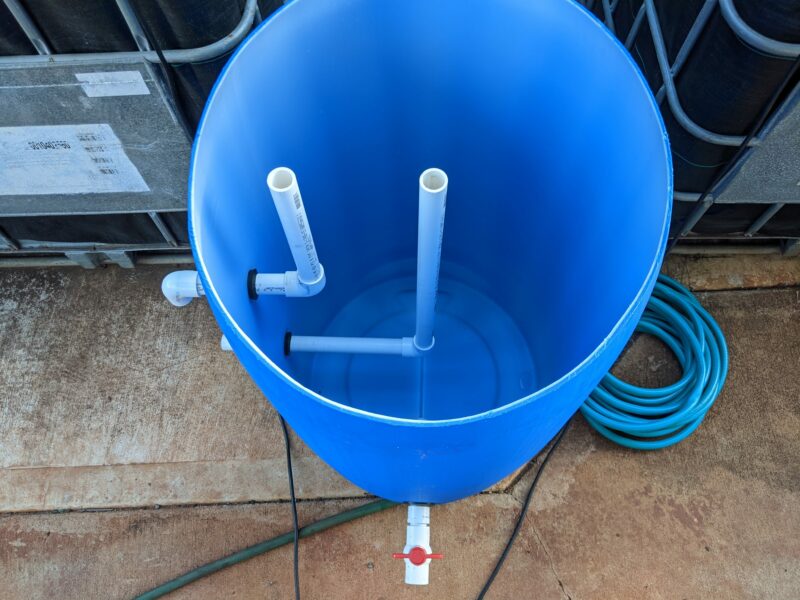 The inside plumbing for my radial flow filter. The bottom is a ball valve to remove the solids, the middle pipe is where the water from the fish tank will enter, and the left pipe is the exit tank where clean water will leave the filter and pour into the grow bed.
