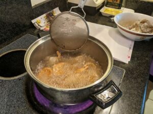 Mom likes to use a small sift utensil to move the shrimp around once or twice as it cooks.