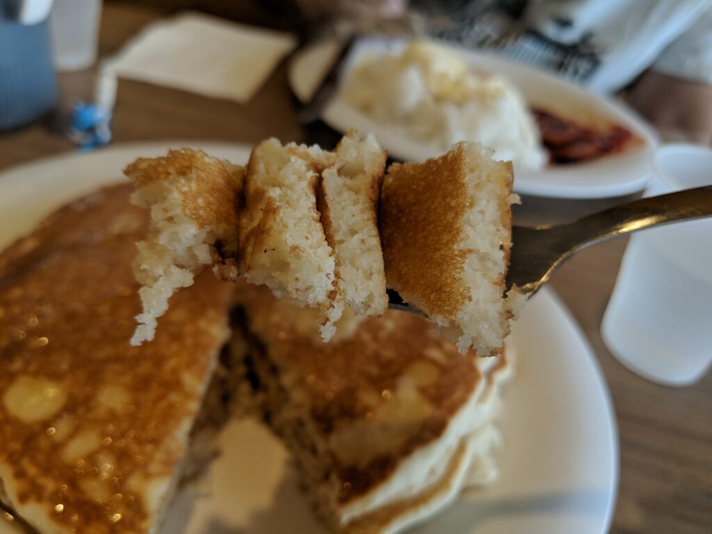 My first bite of pancakes.