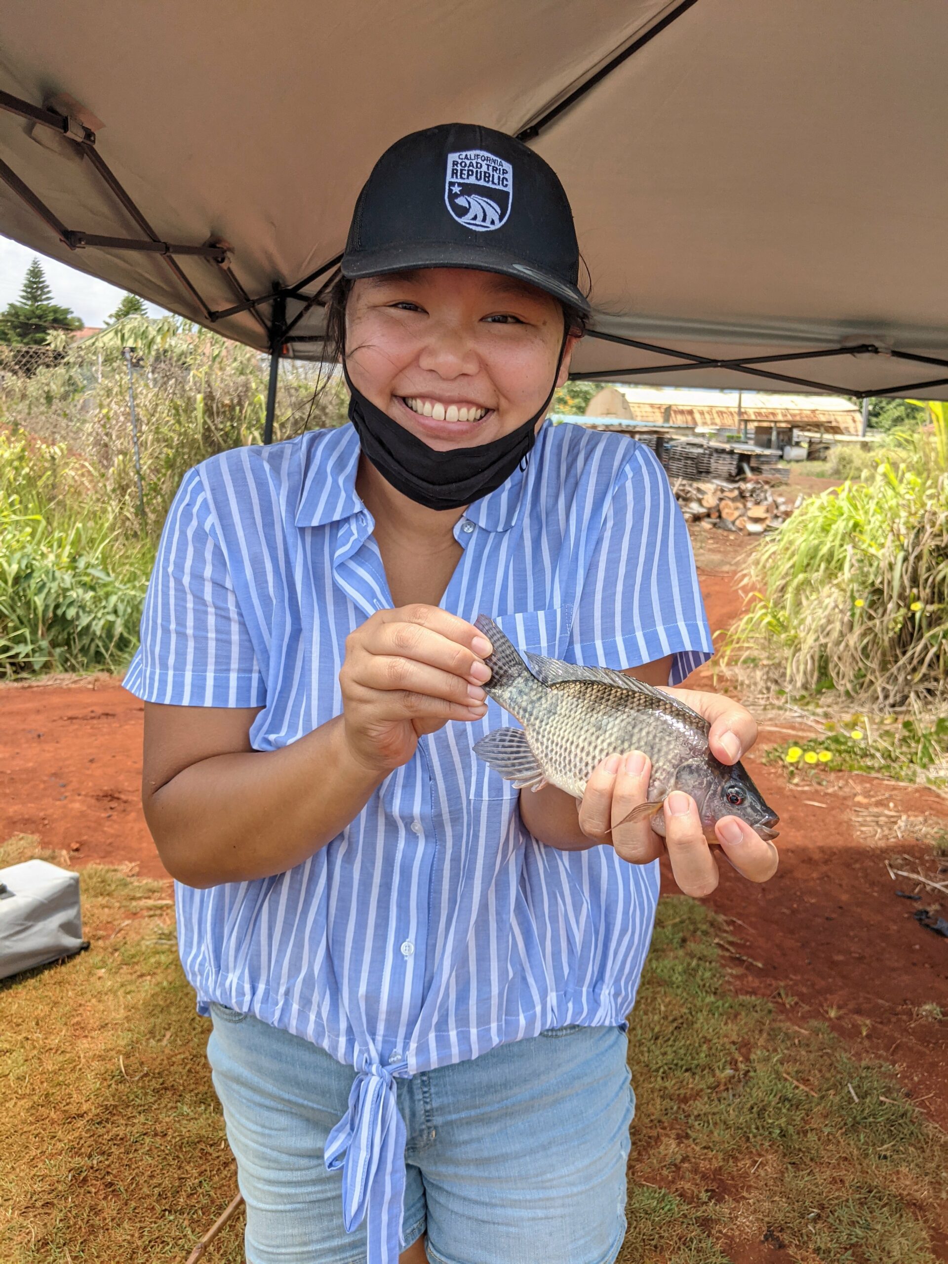 Amy holding a small tilapia.