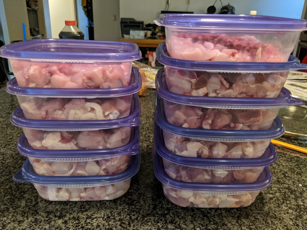 Plastic containers holding raw meat.