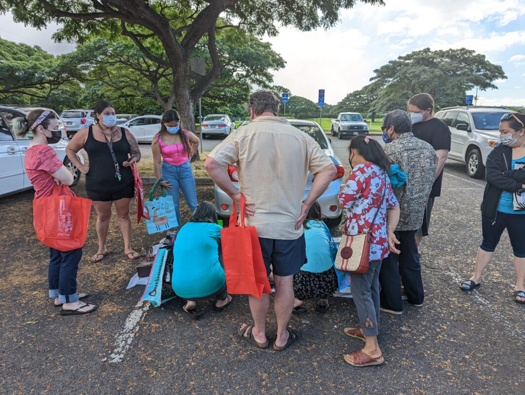 A small crowd in the parking lot.