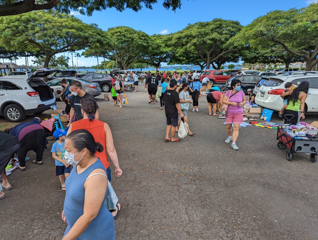 People shopping at a parking lot.