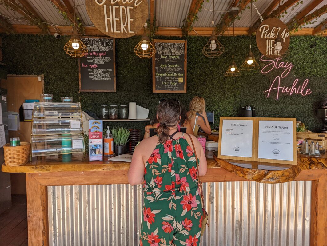 Woman ordering at a counter.