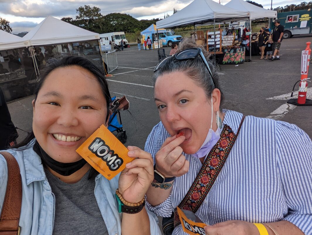 Two women eating candy.