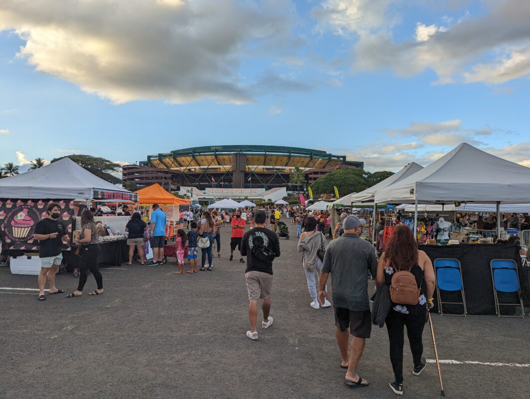 Aloha Stadium with several white tents in the parking lot.