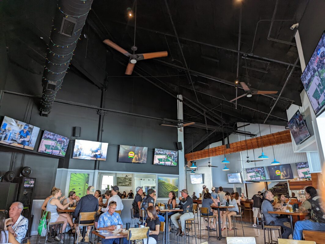 Inside a crowded restaurant with TVs.