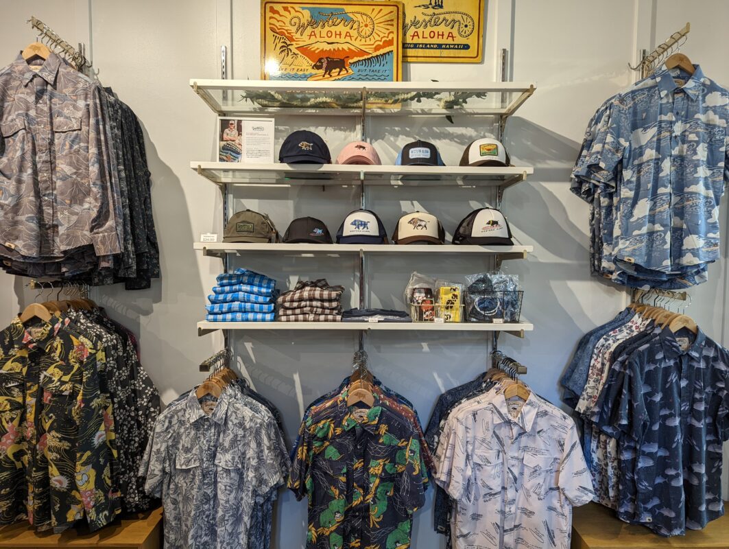 Aloha shirts and hats on display.