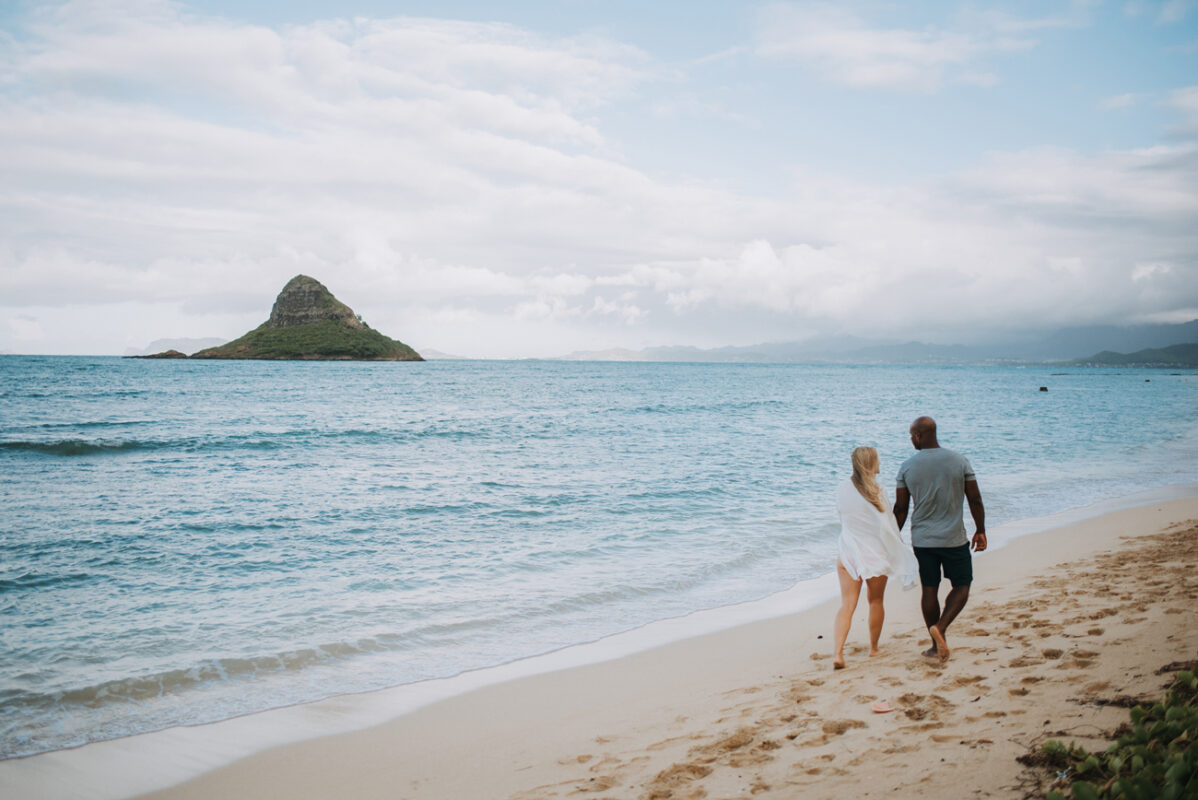 Couple walking on beach.