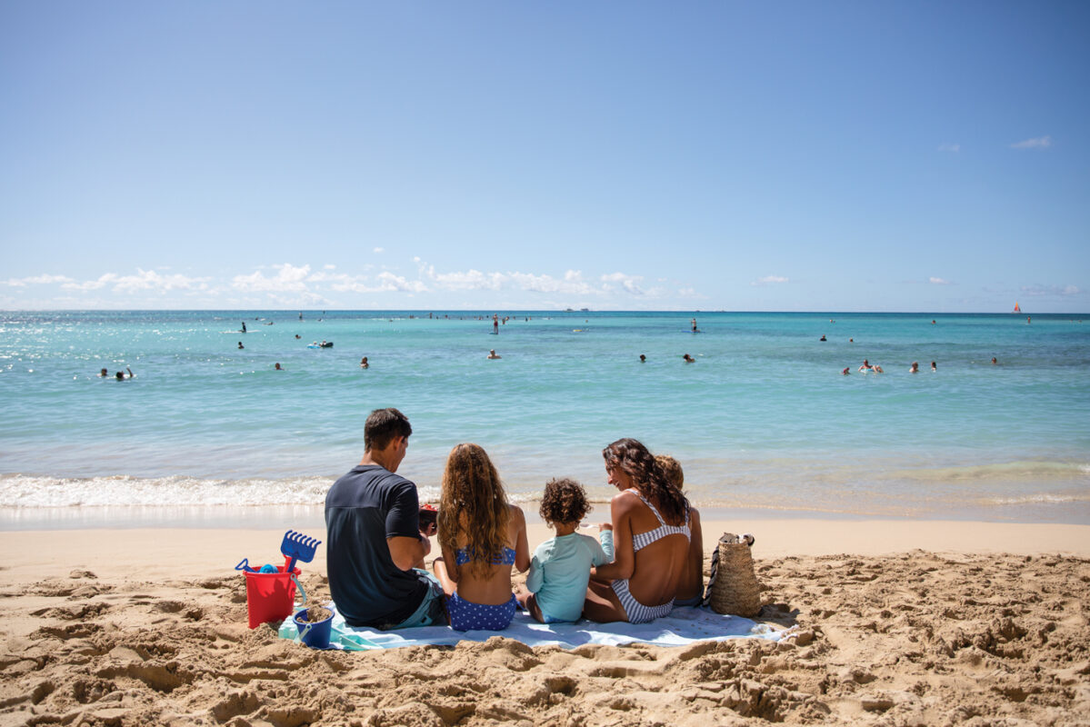 Family picnicking on the beach.