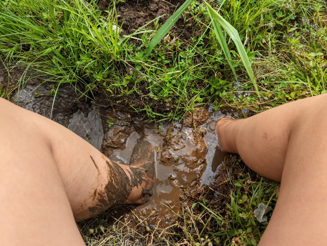 Feet in muddy water.